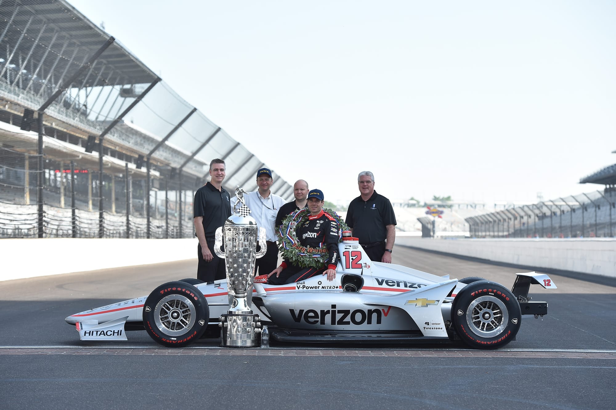 From left to right: John Norton, Andrea Toso, Chris Beatty (designer), Will Power (driver), Pat Wildermann, with the Wills Borg-Warner Trophy Pictured at the Indy500 2018.