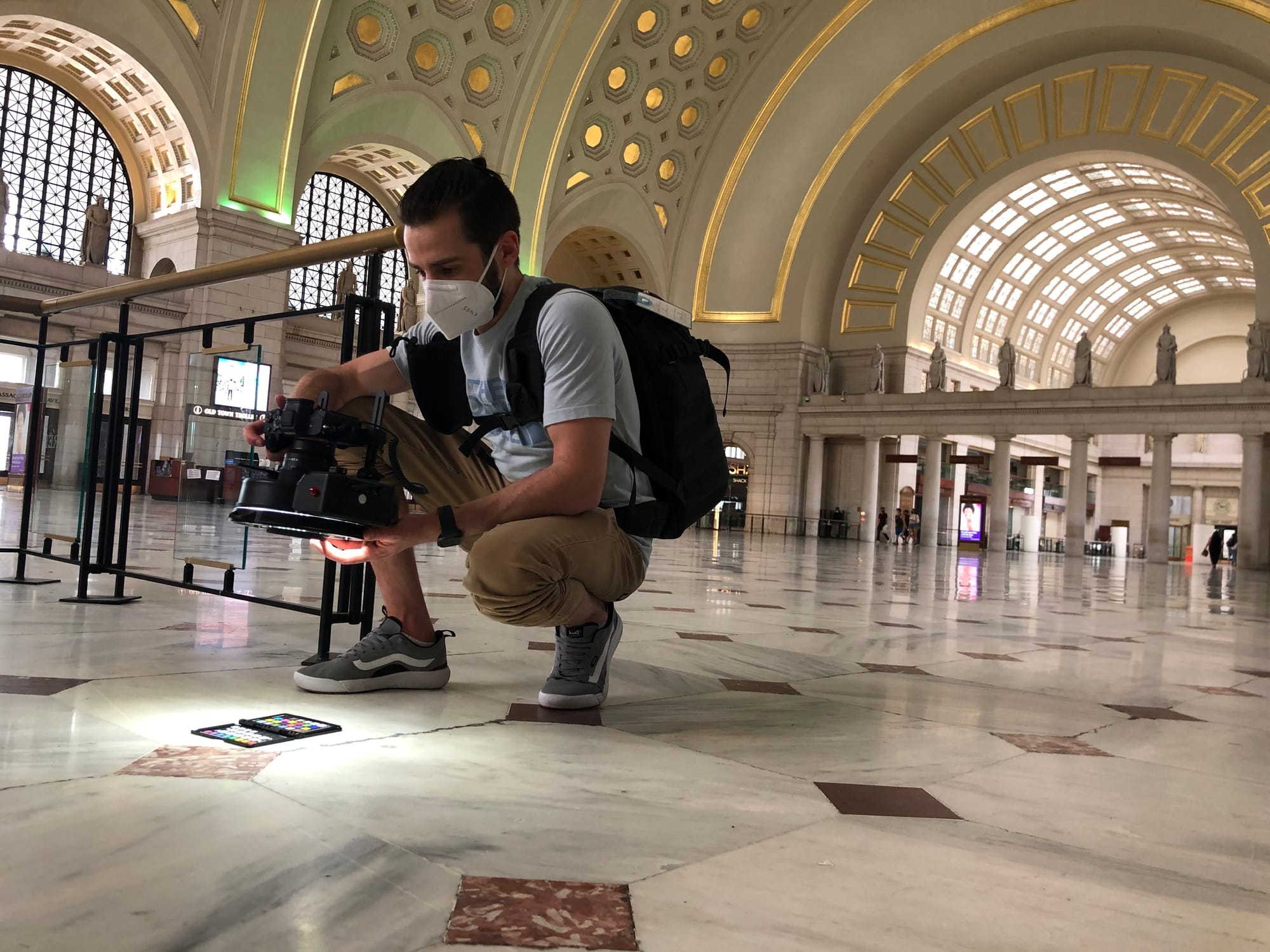 Photograph of 3D artist capturing photogrammatry references of a tiled floor